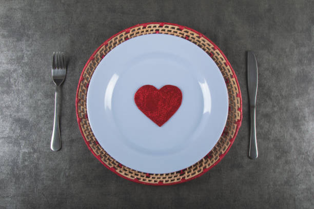 istock Valentines day background with white plate with heart top view. 1296063737
