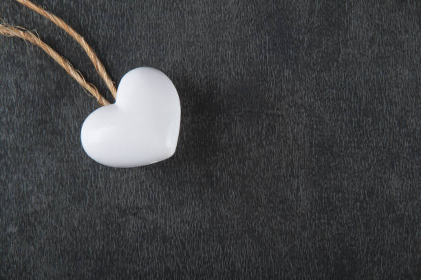 istock Valentines day background with white heart on gray background. 1296063915
