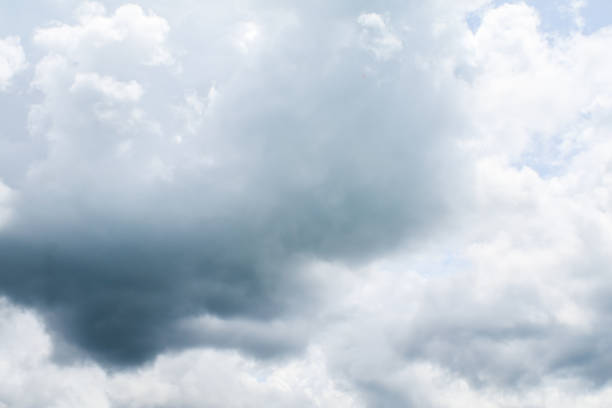 istock Cloudy sky on the horizon above the water. Nature background. Dramatic gray and white clouds in the blue sky. 1296063997