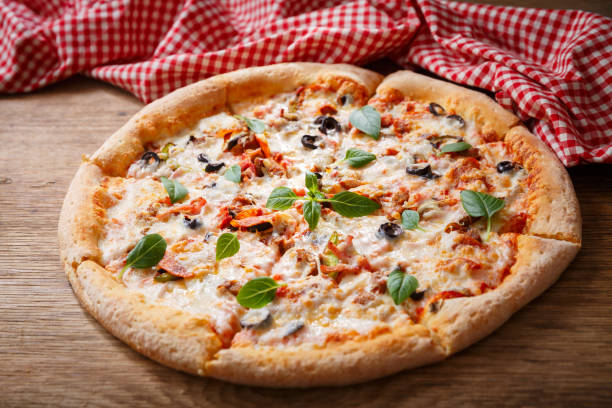 istock pizza with mozzarella cheese, ham, vegetables and pepperoni 1296067514