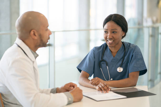 istock Doctor and nurse talking together 1296068809