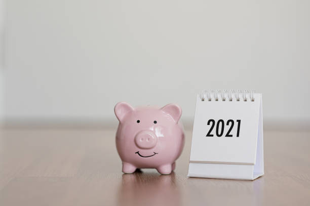 calendar year 2021 and piggy bank on wooden floor. concept finance business investment - stock market data insurance savings finance imagens e fotografias de stock