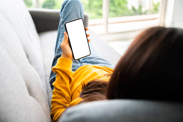 istock Woman using mobile smartphone and device white screen empty space smart phone, clipping path included 1296069808