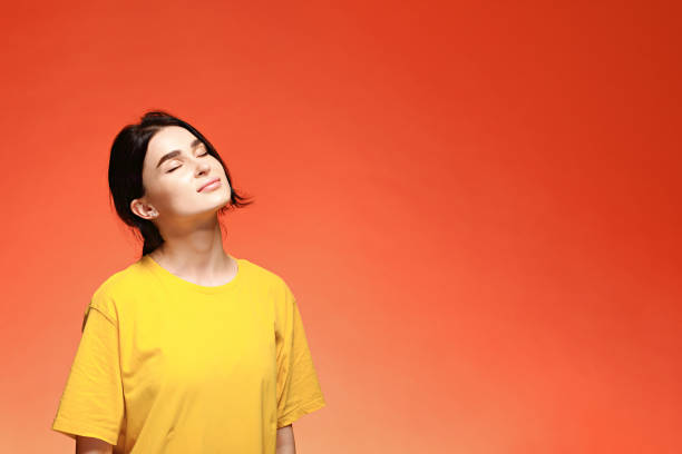 istock Dreaming young woman with closed eyes 1296073080