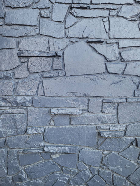 Silver painted Rock wall Silver painted Rock wall stone wall stone wall crag stock pictures, royalty-free photos & images