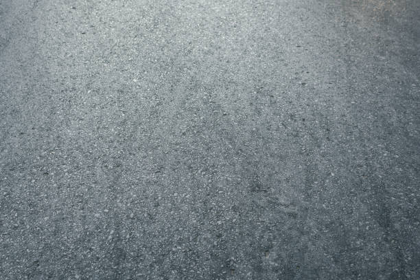 istock Closeup horizontal view of new asphalt road 1296076886