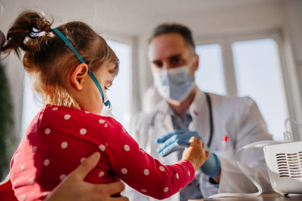 Baby girl holding a doctor finger Baby girl holding a doctor finger pediatric nebulizer mask stock pictures, royalty-free photos & images