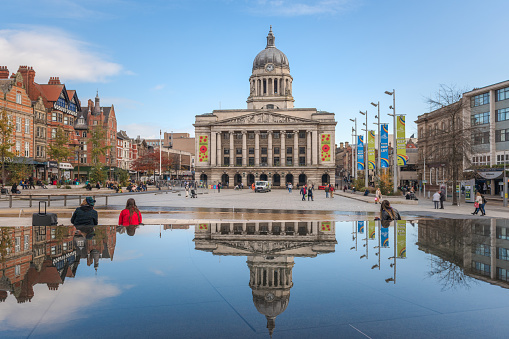 Nottingham, England - January 13, 2021:  The imposing Nottingham Council House stands high above Nottingham's city centre acting as a backdrop to Nottingham's Old Market Square, which is in the foreground.