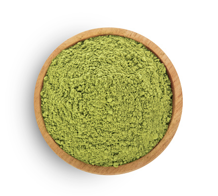 Top view of green tea powder in bowl on white background