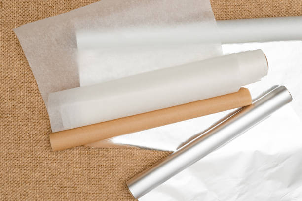 istock Different type of paper for baking needs. Parchment paper, foil, wax paper close up on rustic background, flat lay 1296087533