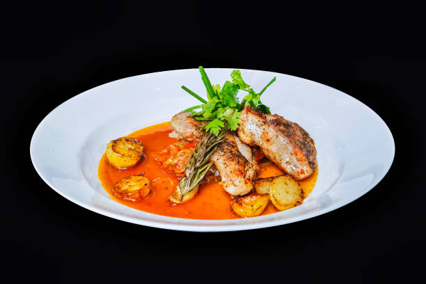 istock Lemon Basil Roast Chicken with Potatoes in black background 1296090180