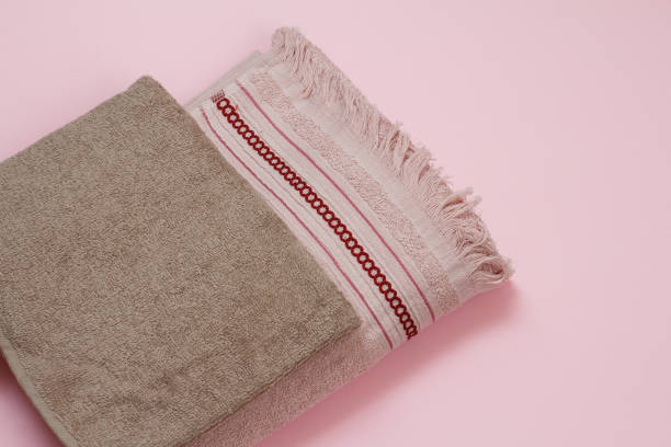 istock Brown and red terry towels on pink background. 1296090966