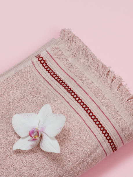 istock Soft terry towel with flowers on pink background. 1296091048