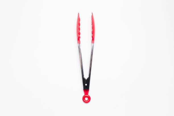 Close-up of kitchen tongs on white background.