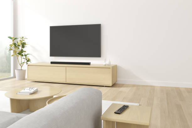 istock 3D rendering of modern living room with sofa and hanging television screen on white wall. 1296093676