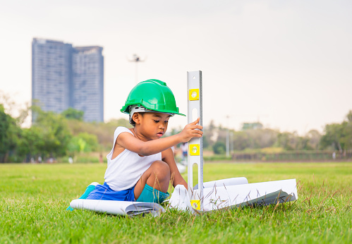 Portrait of happy african american kids boy playing outdoors in a park, Kid playing construction worker concept.