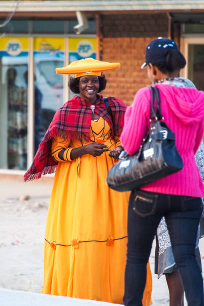 Herero Woman in traditional clothes in Opuwo. Namibia. Opuwo, Namibia - Jul 06, 2019: Herero Woman in traditional clothes in Opuwo. Namibia. The Herero belonging to the Bantu group, with about 240,000 members alive today. kaokoveld stock pictures, royalty-free photos & images