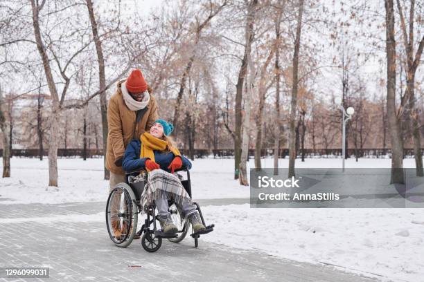 Disabled woman with assistant