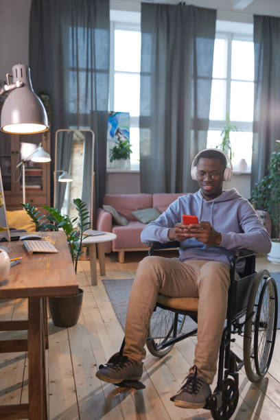 istock Disabled man sitting at home 1296099186