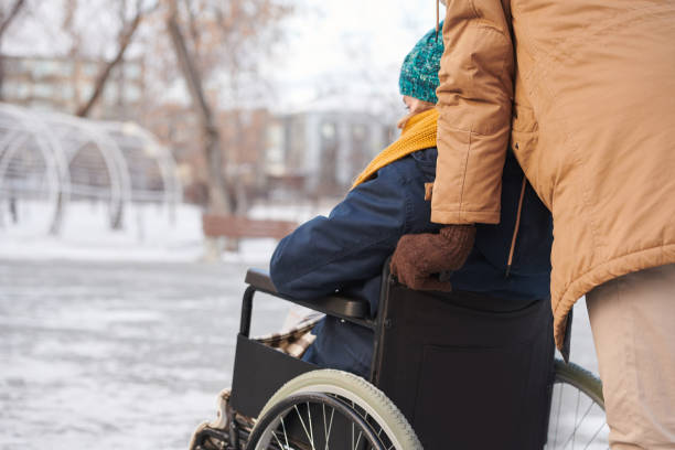 istock Disabled woman walking in the park 1296100064