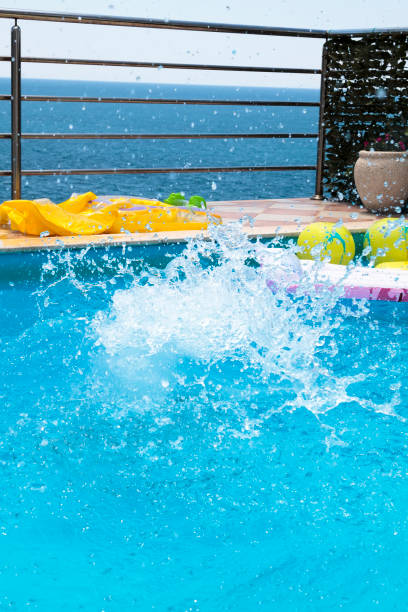 istock water splashes after the baby boy jump into the pool 1296100548