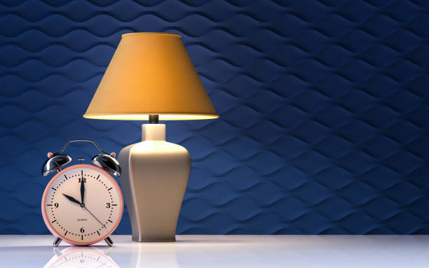 istock Yellow lamp and alarm clock on blue background - interior - 3d rendering 1296101823