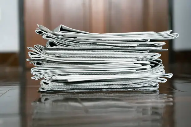 Photo of A pile of newspaper on the floor