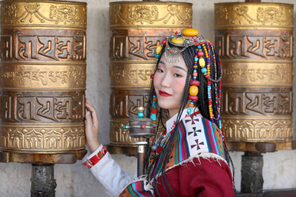 A young woman praying around the white pagoda