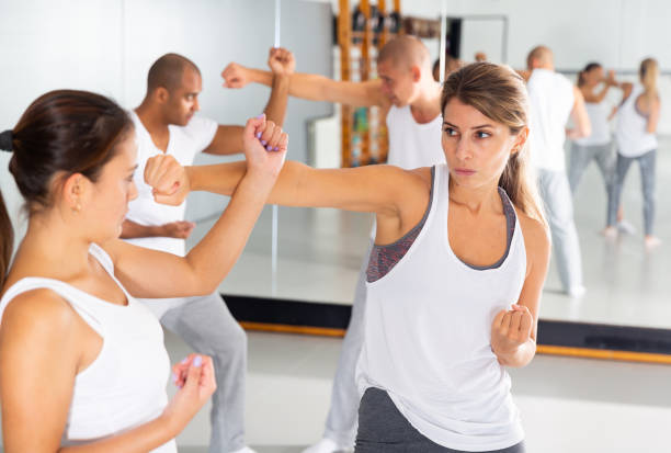 istock Womens sparring in self defense courses in gym 1296106914