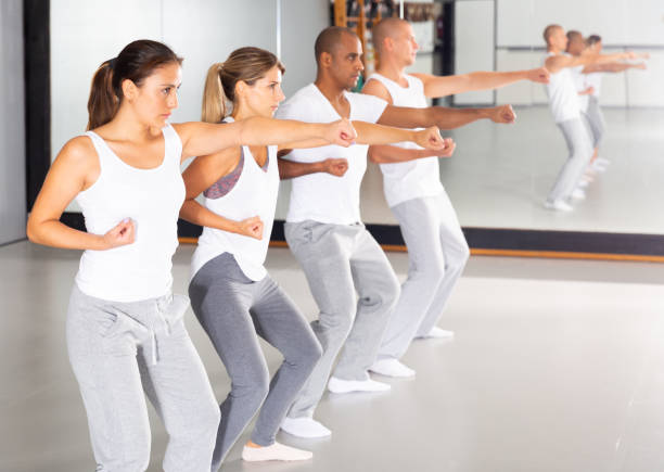 istock Men and women train in self defense courses in gym 1296106917