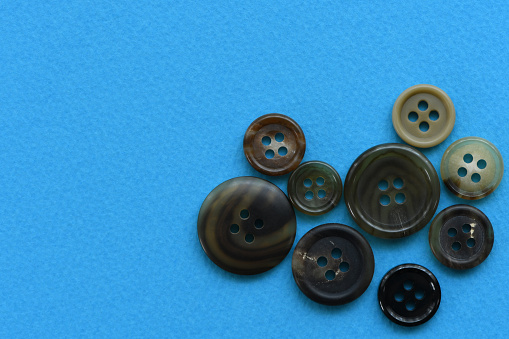 Clothes buttons on Blue background.