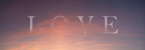 istock Love sign on the evening sky with delicate, pink clouds. 1296108065