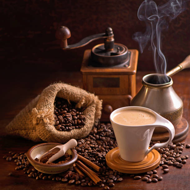 istock cup of coffee and coffee beans in a sack on dark background, top view 1296109270