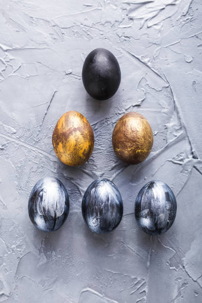 istock Holidays, design and modern easter concept - Black and brown easter eggs style minimalism on grey background. 1296110555