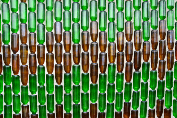 istock Pattern background from glass  bottles, Background with glass bottles  on the wall 1296111187