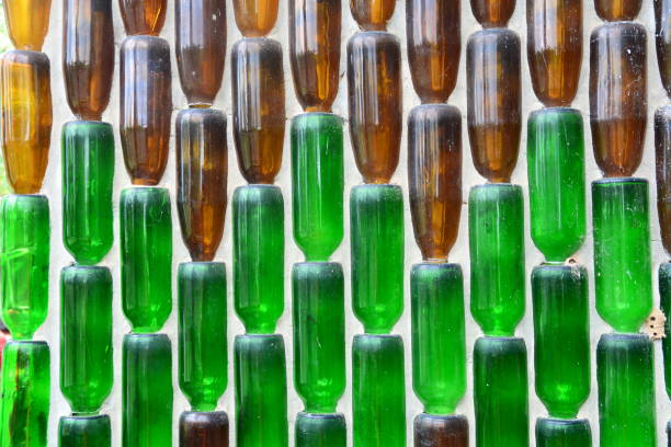 istock Pattern background from glass  bottles, Background with glass bottles  on the wall 1296111208