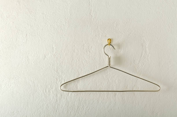 istock Metal hanger on the hook, bright white wall.Empty space 1296111339
