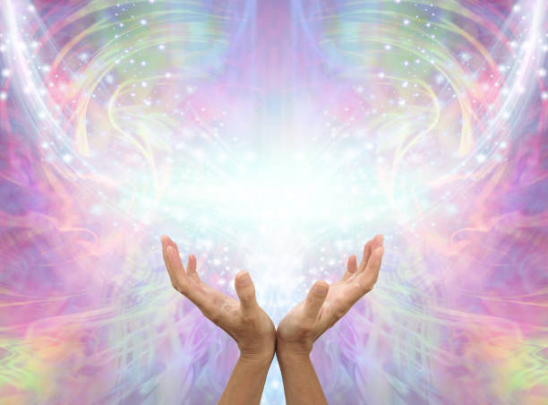 Sending you Distant Healing Assisted by Angels female cupped hands reaching up into an Angelic shimmering sparkling  pink ethereal energy background with copy space spiritual enlightenment stock pictures, royalty-free photos & images