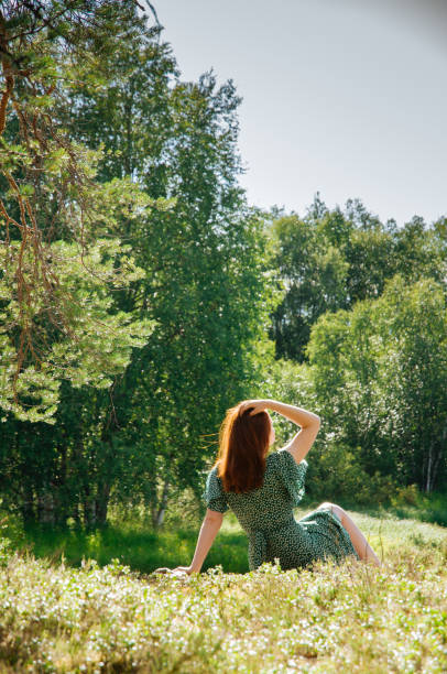 istock Young attractive red-haired girl in a pine forest 1296113171