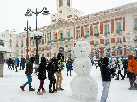 Madrid, Spain, 01.09.2021, A snowman on a Square Sol in Madrid central, it's snowing, The storm Filomena
