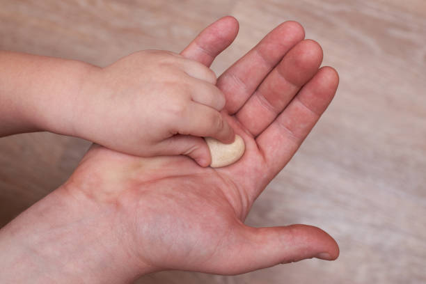 istock The little son puts a small plaster heart in his dad's hand. 1296120988