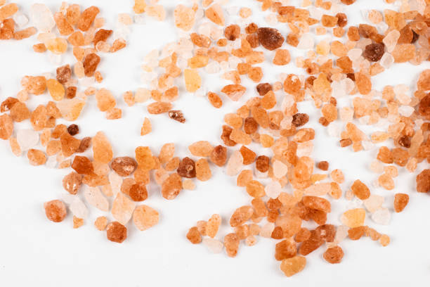 istock Pink himalayan salt on a white background with visible details 1296121336