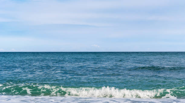 istock Blue sea with waves and cloudy sky 1296123141