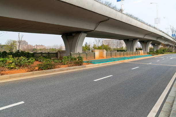 istock Concrete structure and asphalt road space under the overpass in the city 1296125866