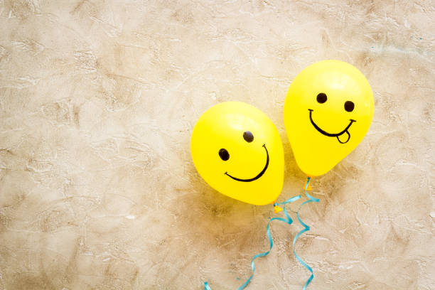 istock Positive emotions set. Happy and winking emoticons painted on colored balloons 1296127631