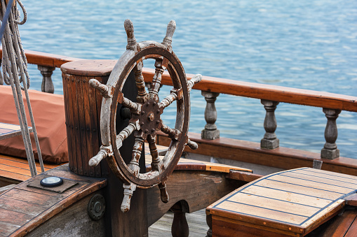 steering wheel made of wood on a yacht