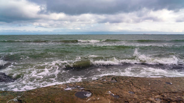 istock Wave splashing at the rocks, freshness on beach 1296129473