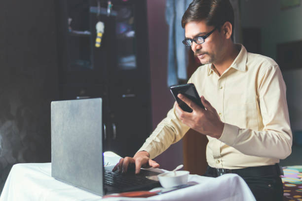 istock man working at home and using laptop. Business at home 1296131679