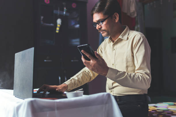 istock man working at home and using laptop. Business at home 1296131708