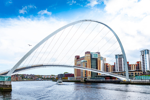 Gateshead Millennium Bridge open to allow a river cruiser to exit East towards Tynemouth.